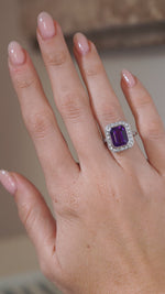 A video of an antique Art Deco amethyst and diamond cluster ring modelled on a hand, highlighting the rich purple amethyst, geometric diamond halo and intricate white gold setting.