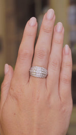 A video of A Vintage, 1950s diamond bombe cocktail ring in white gold worn on an outstretched hand