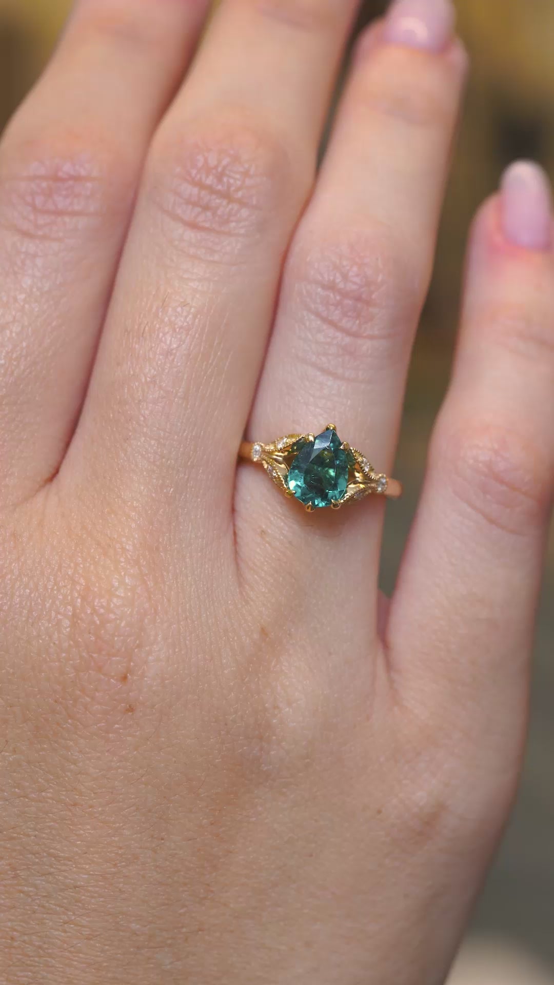 A video of Pear-cut teal tourmaline and diamond engagement ring worn on the hand