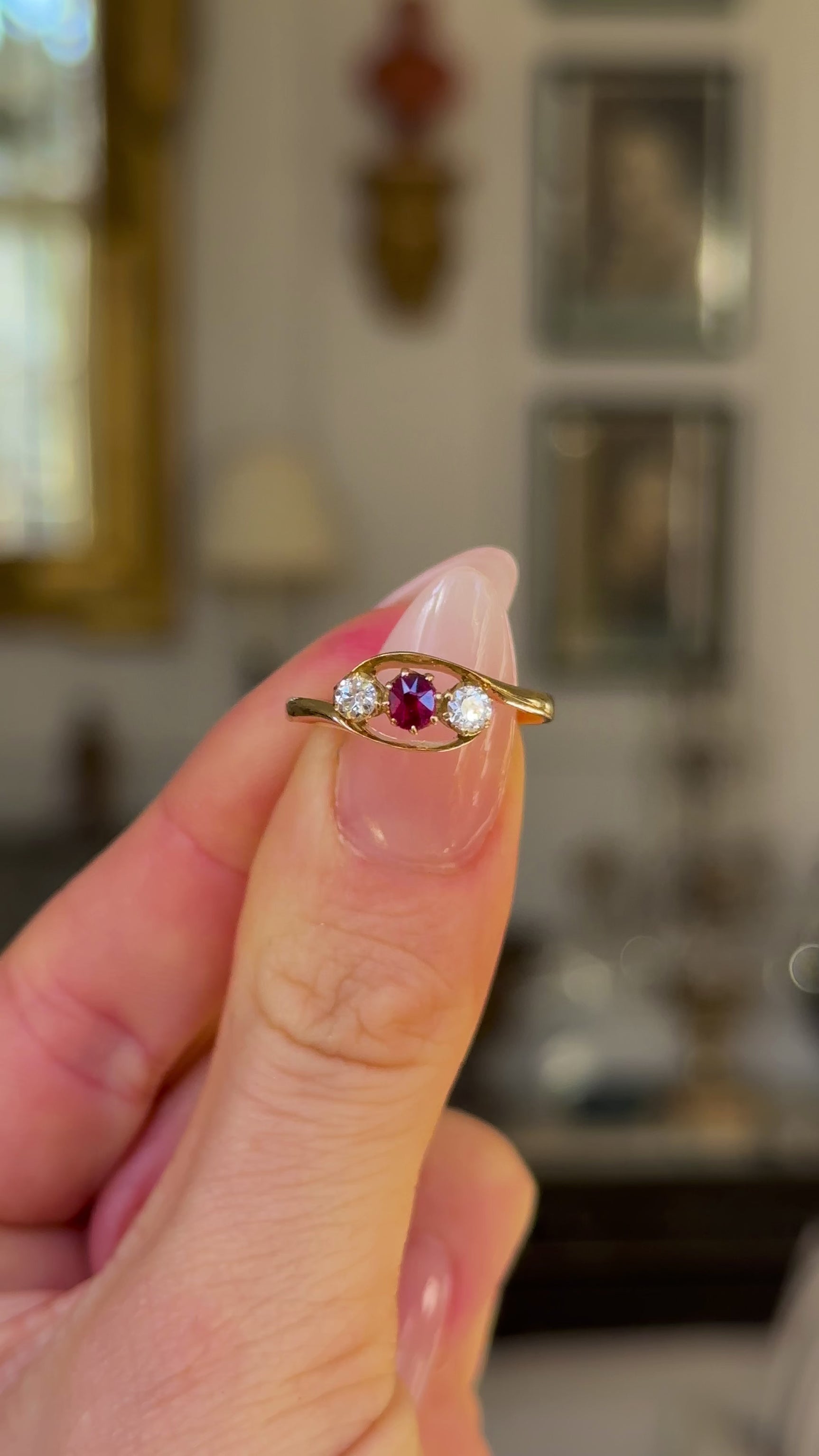 Antique, Three-Stone Ruby and Diamond Engagement Ring, 18ct Yellow Gold held in fingers and rotated to give perspective.