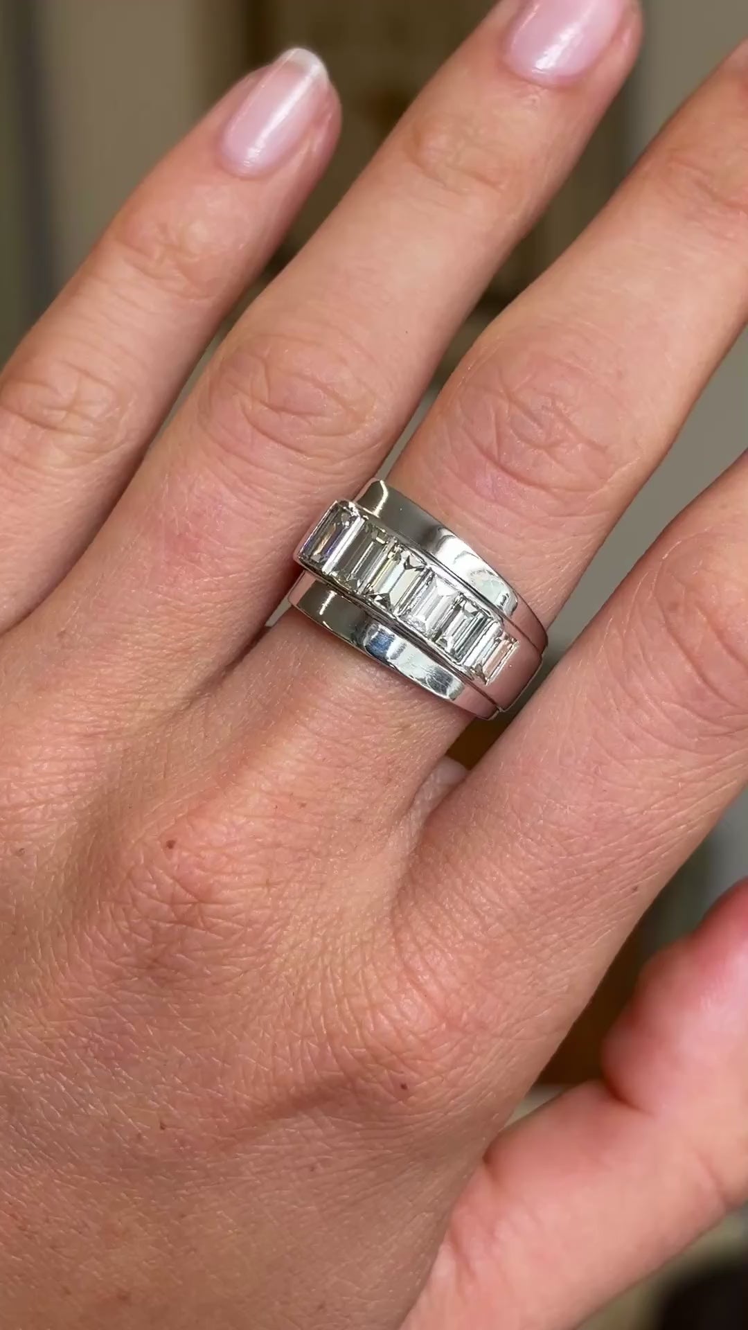 A video of a Vintage, 1940s channel-set baguette-cut diamond ring in platinum worn on a hand