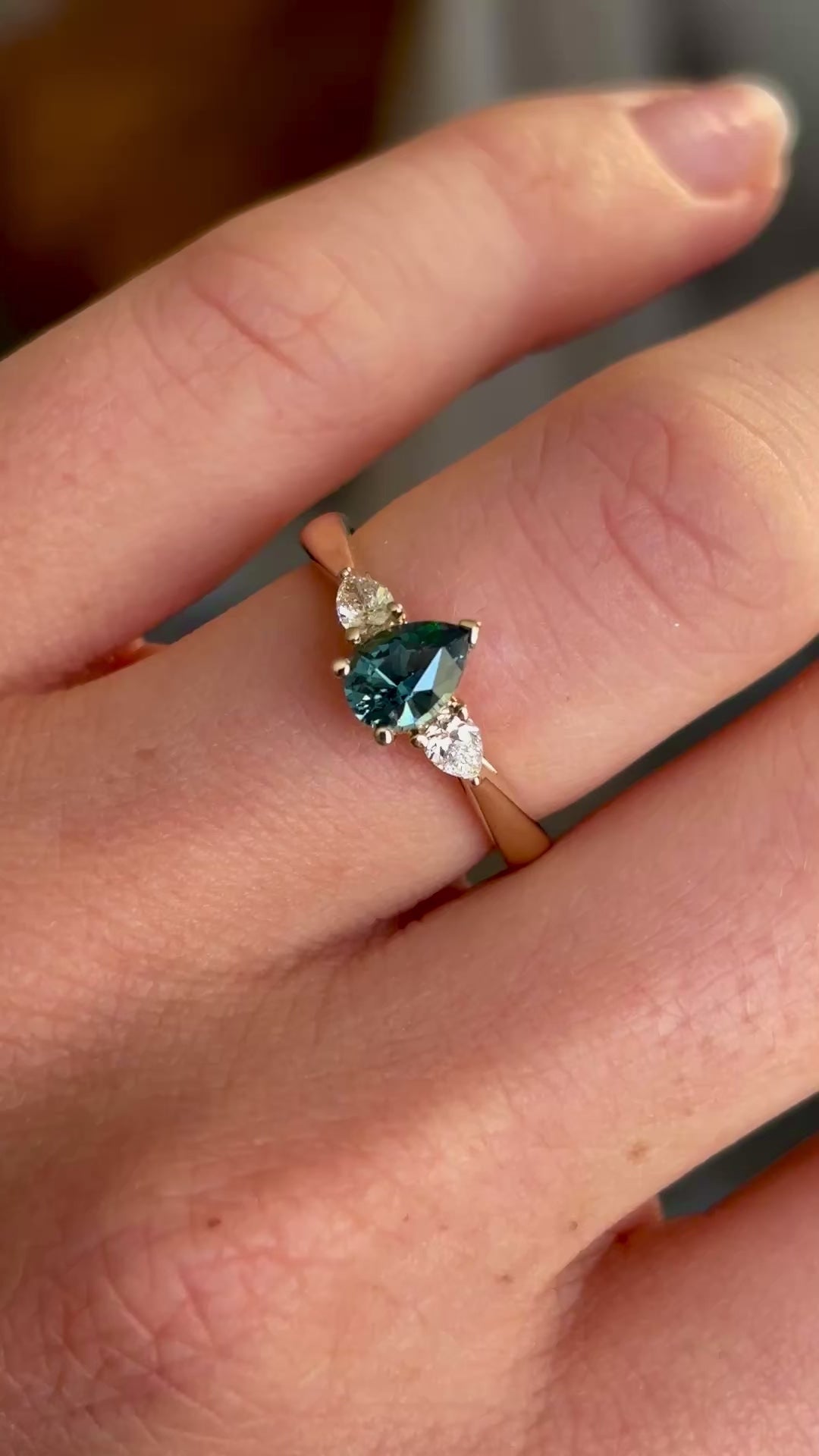 Pear-cut teal sapphire & diamond three-stone ring