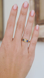 Video of the antique five-stone ring being worn, capturing the contrast between vivid blue sapphires, bright diamonds and warm gold.