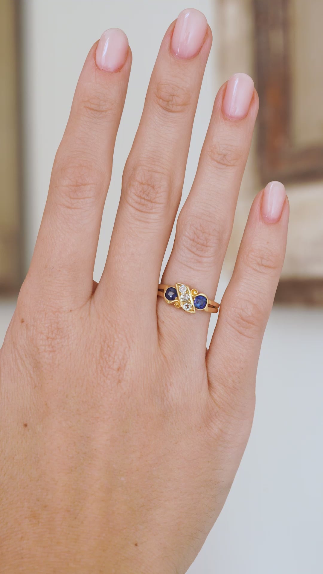 Video of the antique five-stone ring being worn, capturing the contrast between vivid blue sapphires, bright diamonds and warm gold.