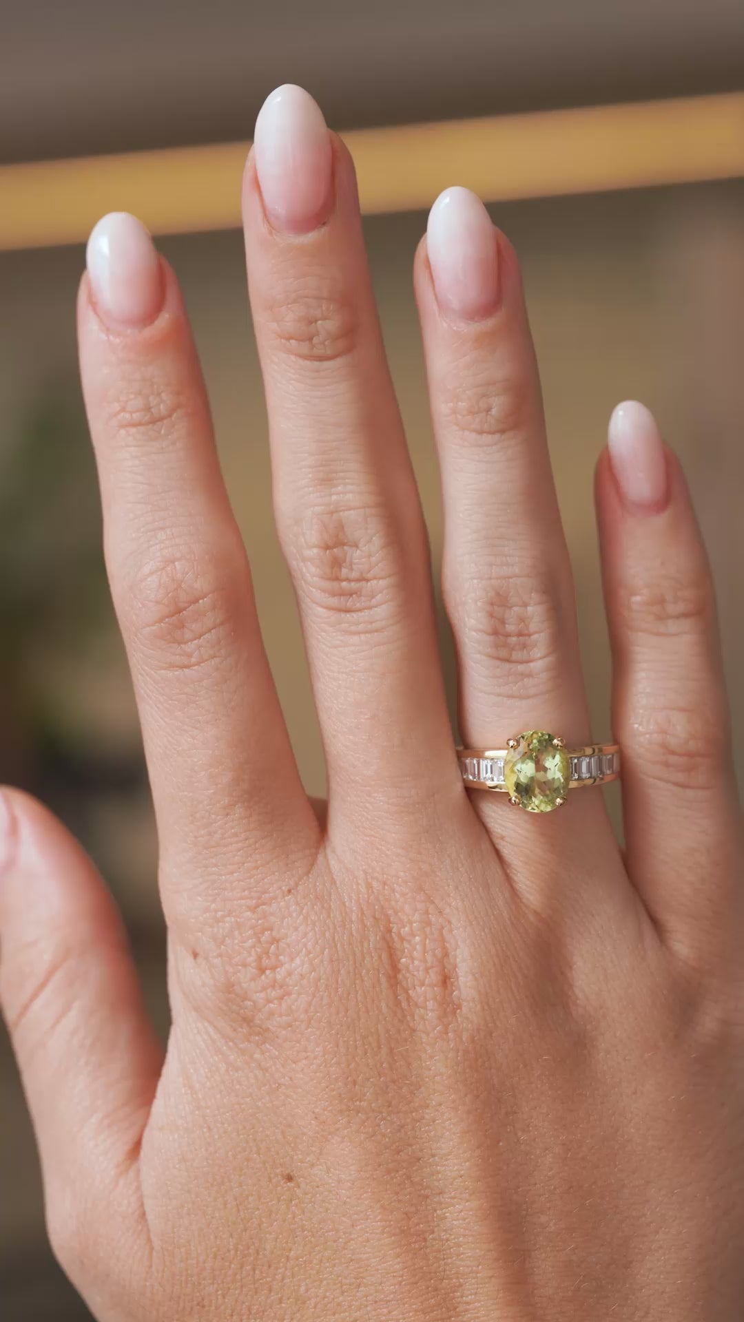 Video of a vintage green beryl and diamond ring worn on the hand, highlighting the sparkle and proportions of the oval-cut gemstone.
