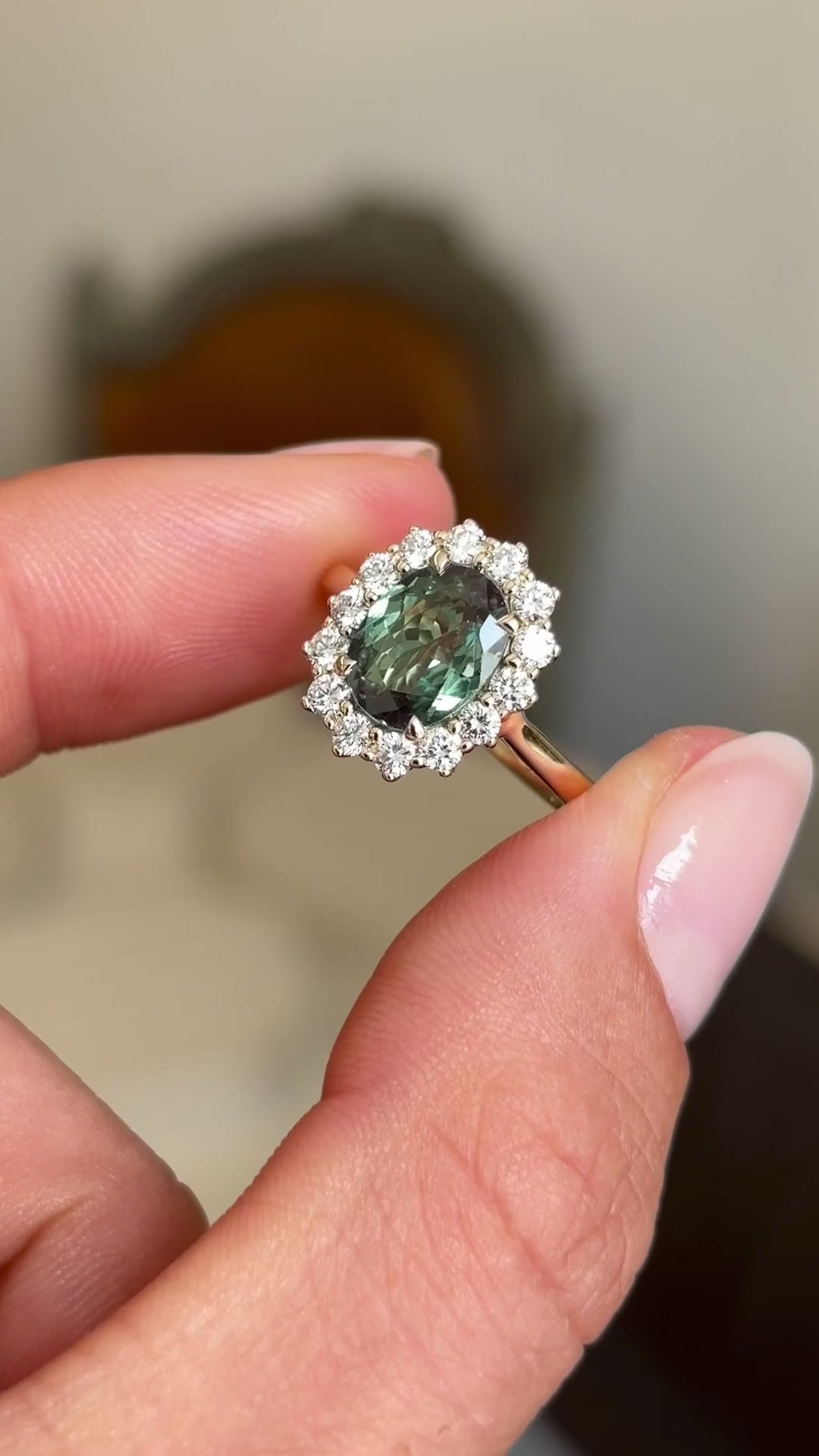 A video showcasing an antique-inspired cluster engagement ring in yellow gold.  Set with a central colour-change alexandrite surrounded by a cluster of round brilliant-cut diamonds. 
