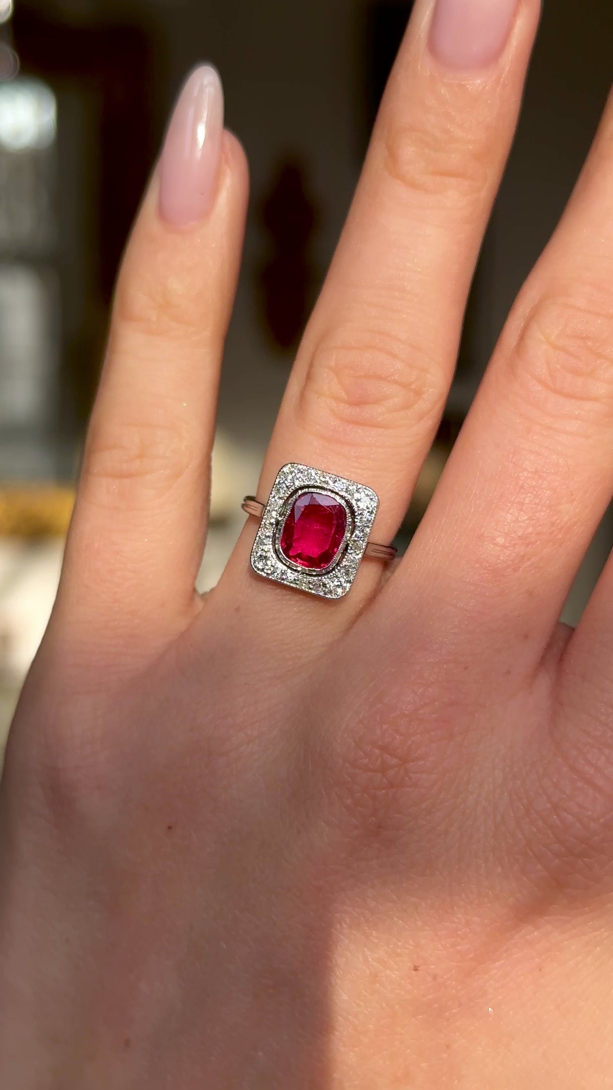 Vintage Art Deco ruby and diamond engagement ring worn on hand and moved around to give perspective.