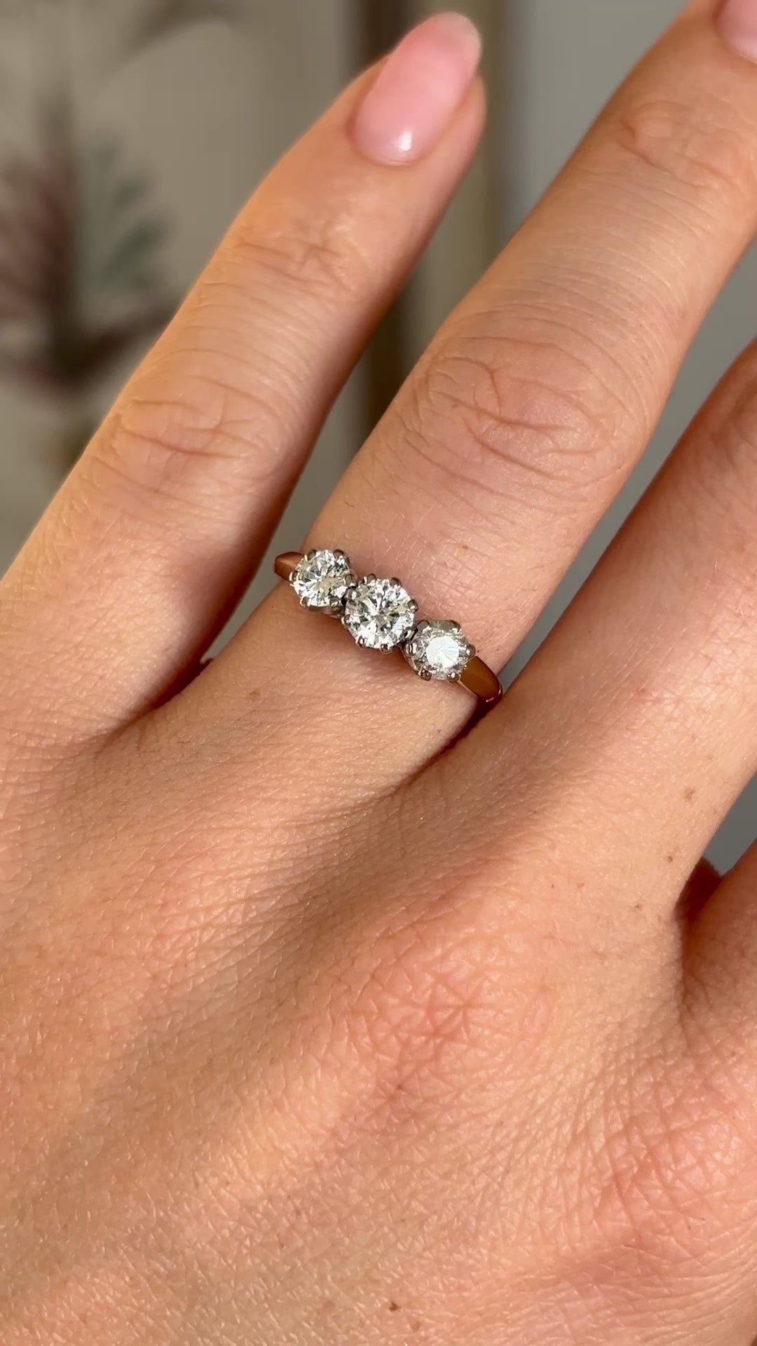 Vintage, 1970s three-stone diamond ring worn on hand.