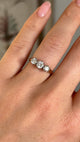 Vintage, 1970s three-stone diamond ring worn on hand.