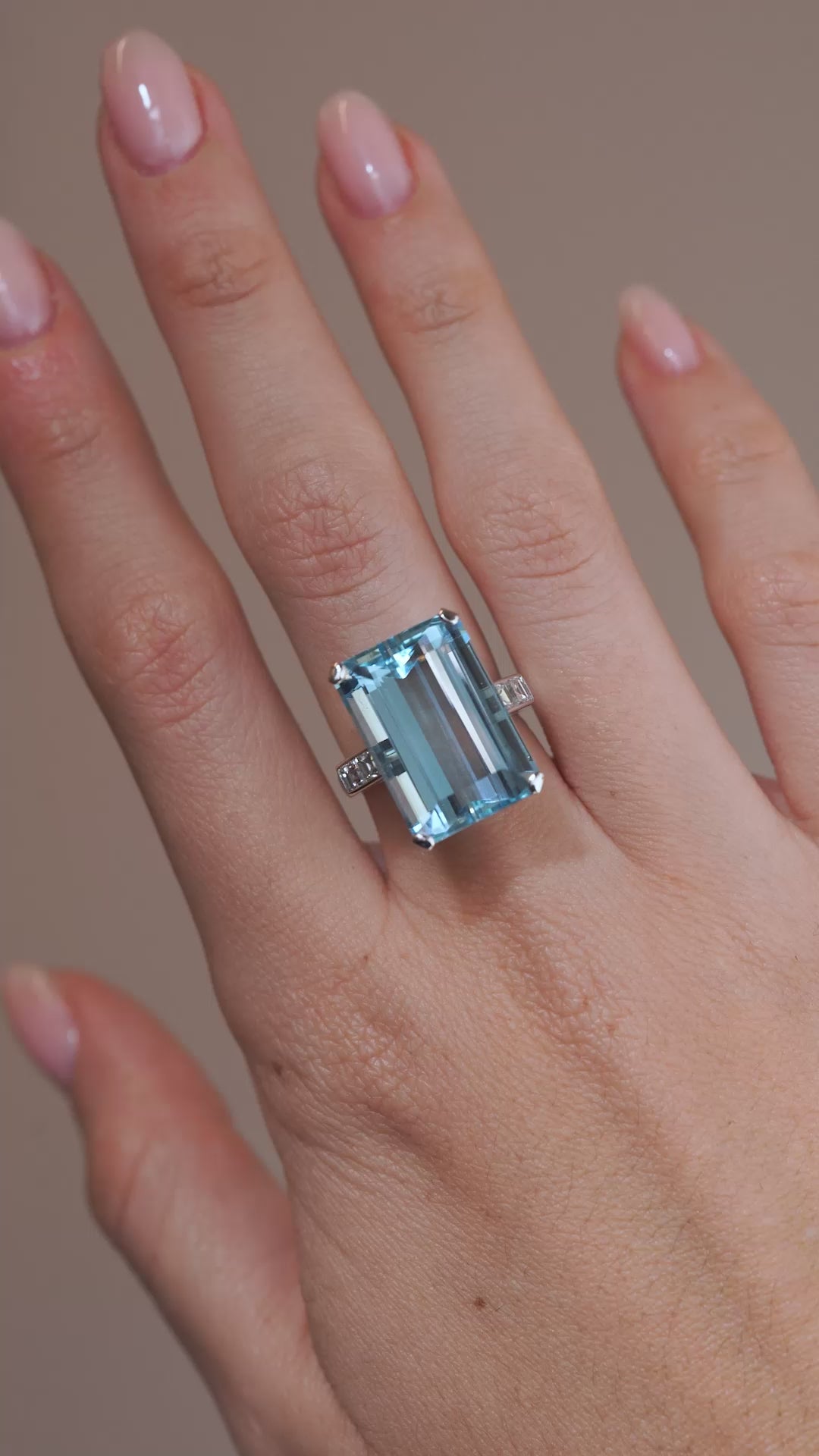 A video of a vintage 1970s aquamarine and diamond cocktail ring modelled on a hand, highlighting the gemstone's icy blue colour, step-cut facets and diamond accents.