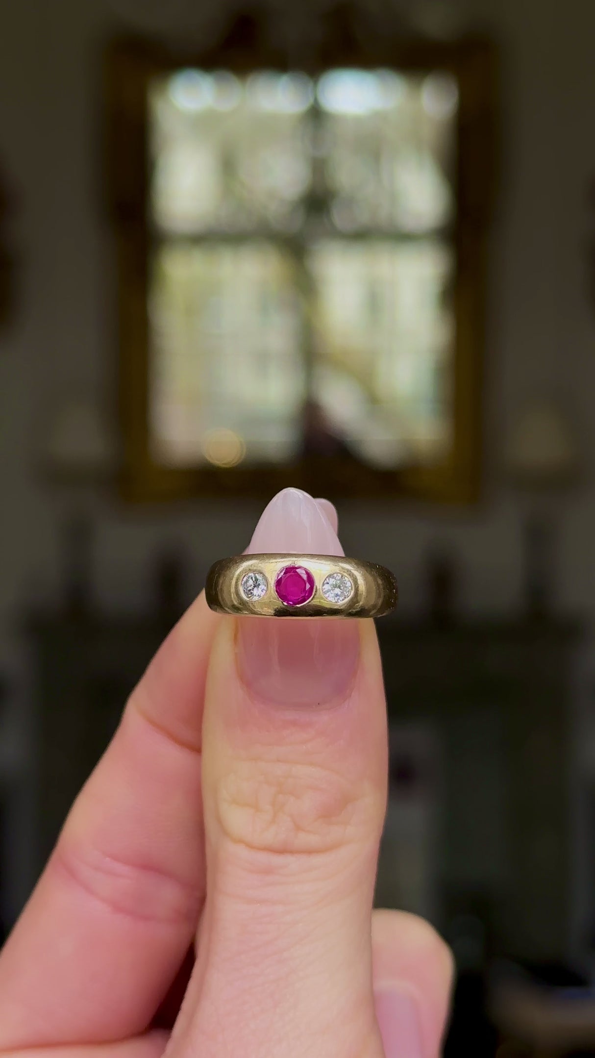 Antique, Edwardian Ruby and Diamond Gypsy Ring, held in fingers and rotated to give perspective.