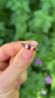 Antique, Edwardian Three-Stone Ruby and Diamond Ring, 18ct Yellow Gold held in fingers.