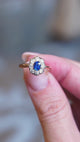 Close detail video of antique Belle Époque sapphire and diamond cluster engagement ring with ornate setting.