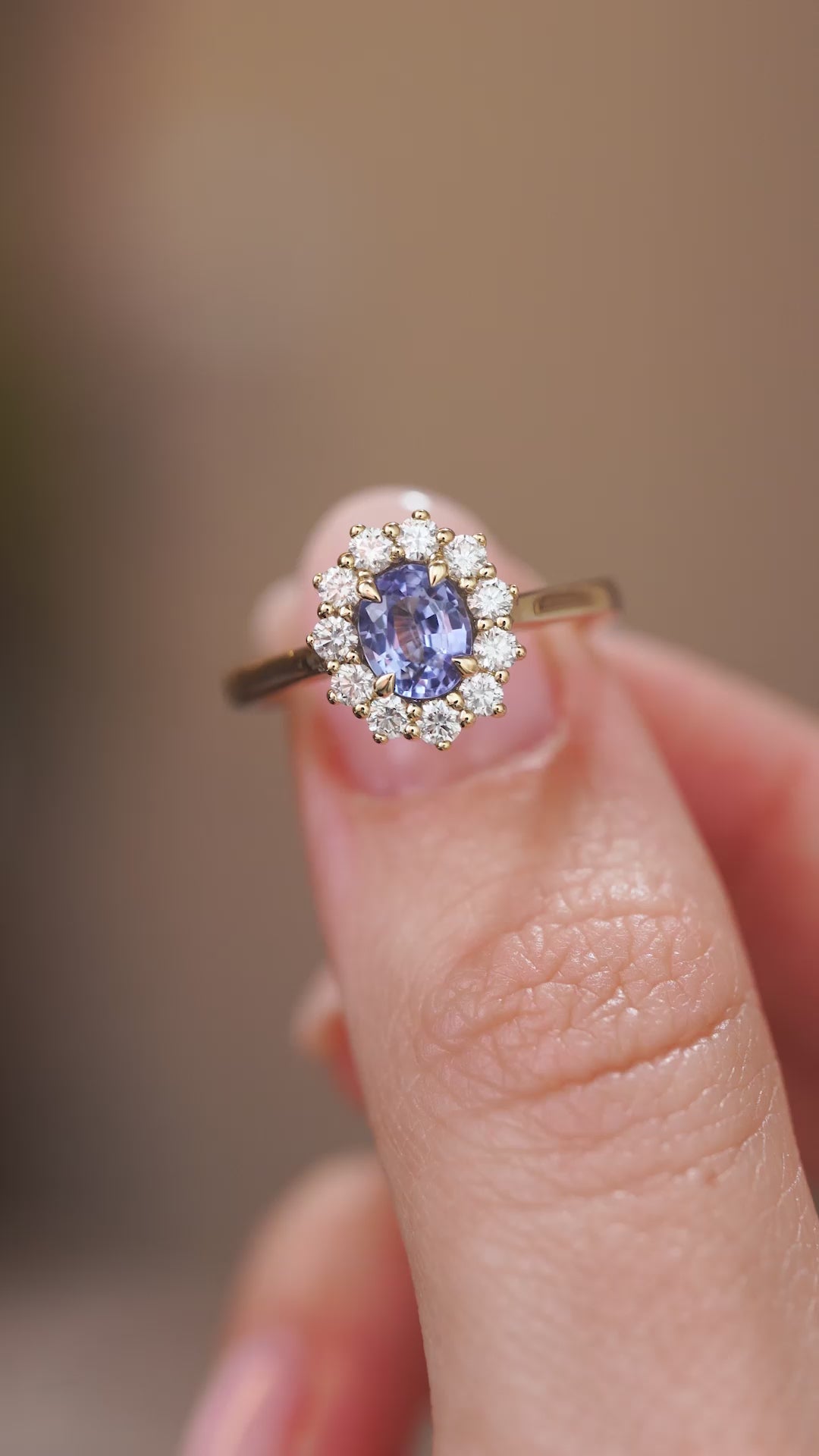 Video presenting the antique-inspired sapphire cluster ring balanced on a fingertip for a detailed face-on view.