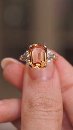 A video of Vintage, 1950s Sherry topaz and diamond cocktail ring held between the fingers and rotated to show angles.