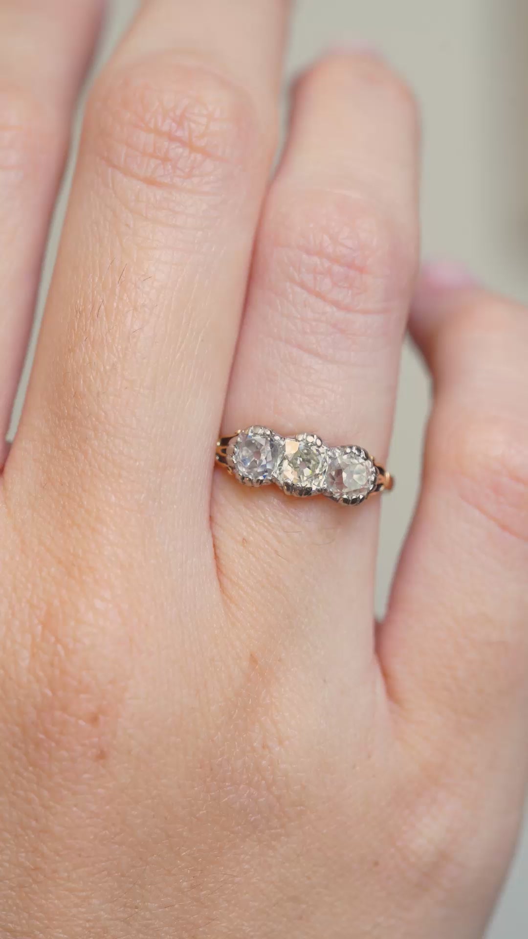 A Video of an Antique three-stone diamond engagement ring worn on the hand