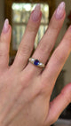 antique sapphire and pearl three stone ring worn on hand and moved around to give perspective.