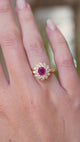 A video showing a vintage 1980s Burmese ruby and diamond cluster ring worn on the finger with a wider view of the hand.