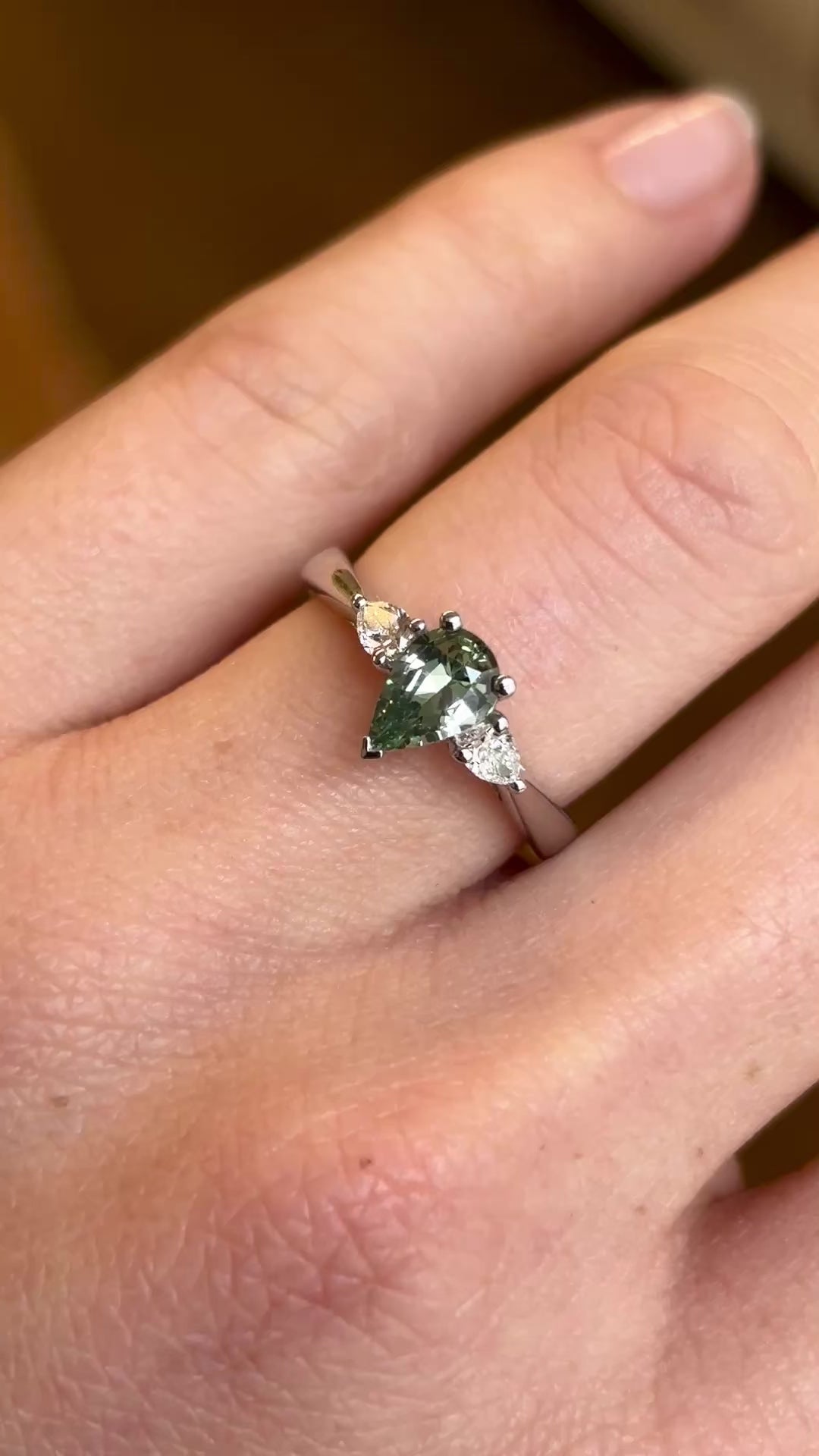 Pear-cut teal sapphire & diamond three-stone engagement ring