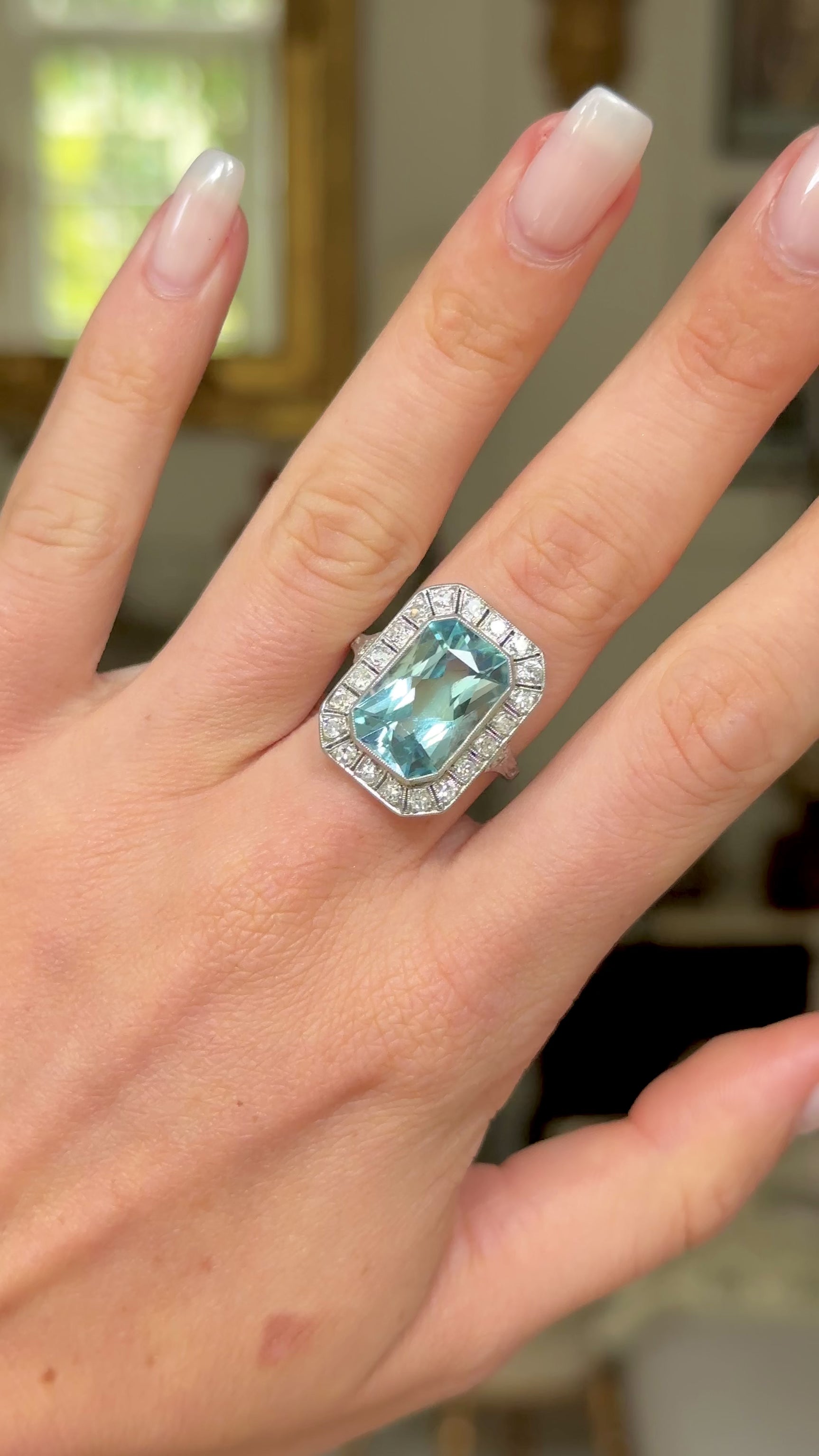 Art Deco aquamarine and diamond cluster ring, worn on hand and moved around to give perspective.