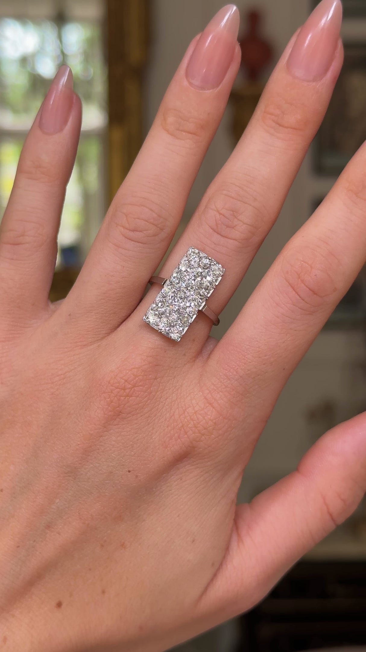 Art Deco diamond panel ring, worn on hand and rotated to give perspective.