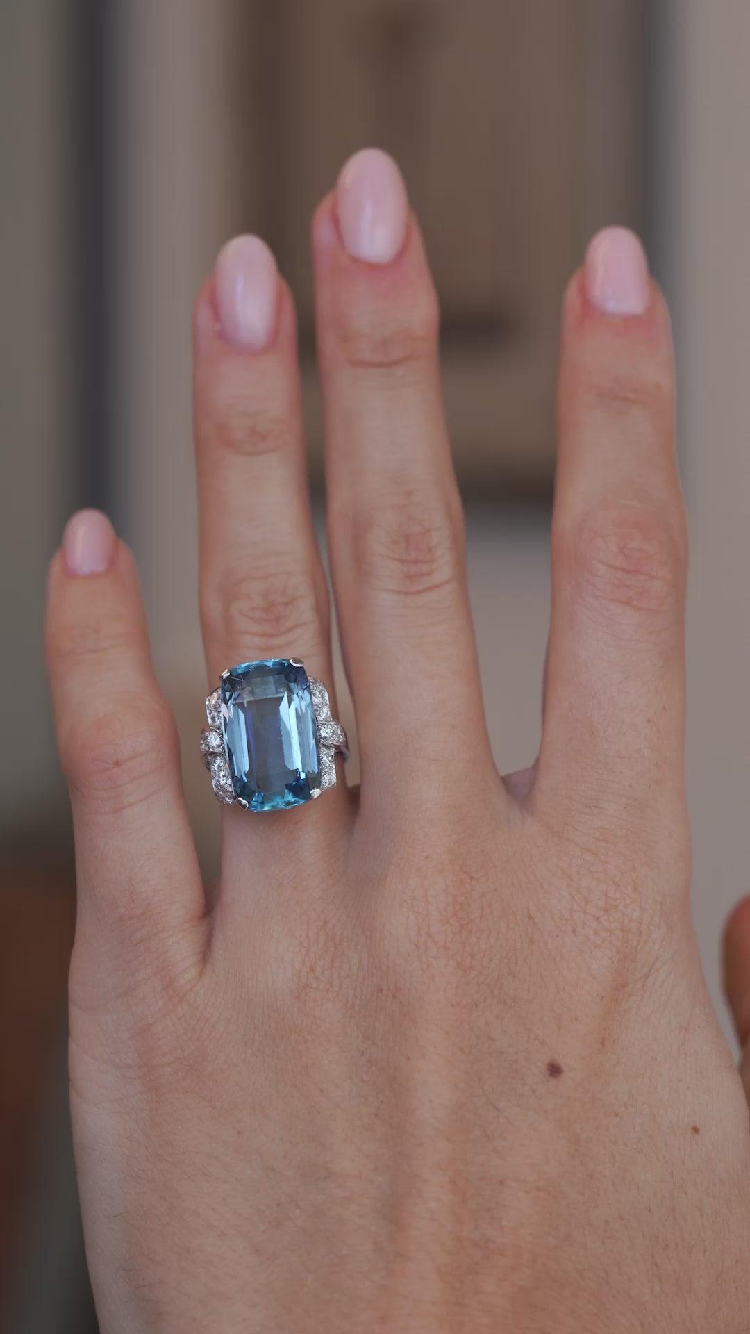 A video of the antique aquamarine cocktail ring worn on a hand, capturing its impressive size and vibrant blue colour.