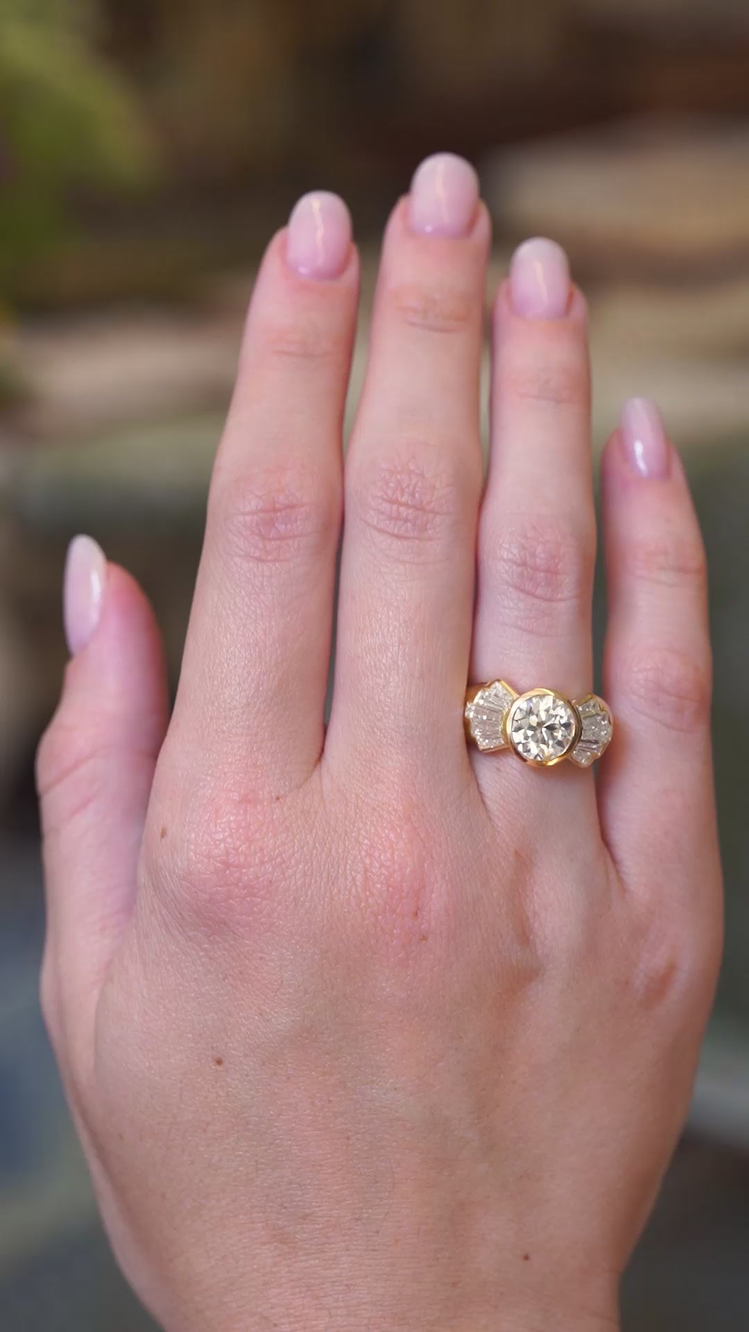 Vintage 1950s old-cut diamond fan engagement ring worn on the hand shown in video.