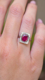 A video of an antique red spinel and diamond halo ring worn on the hand.