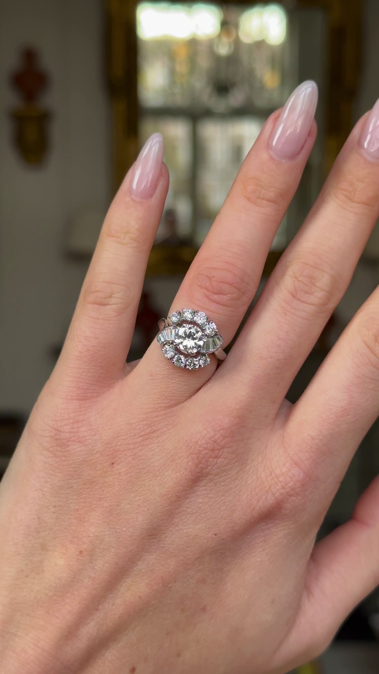 Cartier diamond engagement ring worn on hand and moved around to give perspective. 