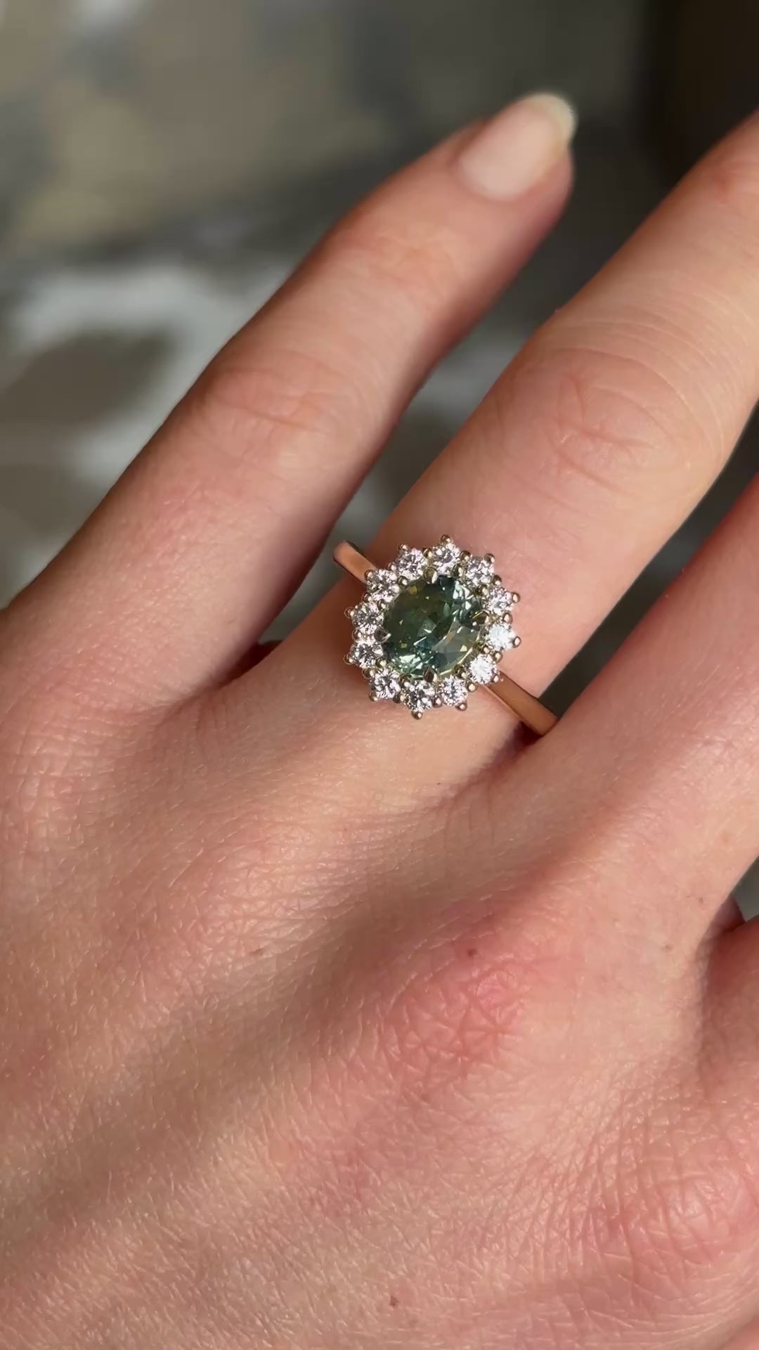 Green sapphire and diamond cluster engagement ring