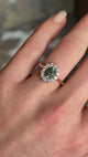Green sapphire and diamond cluster engagement ring