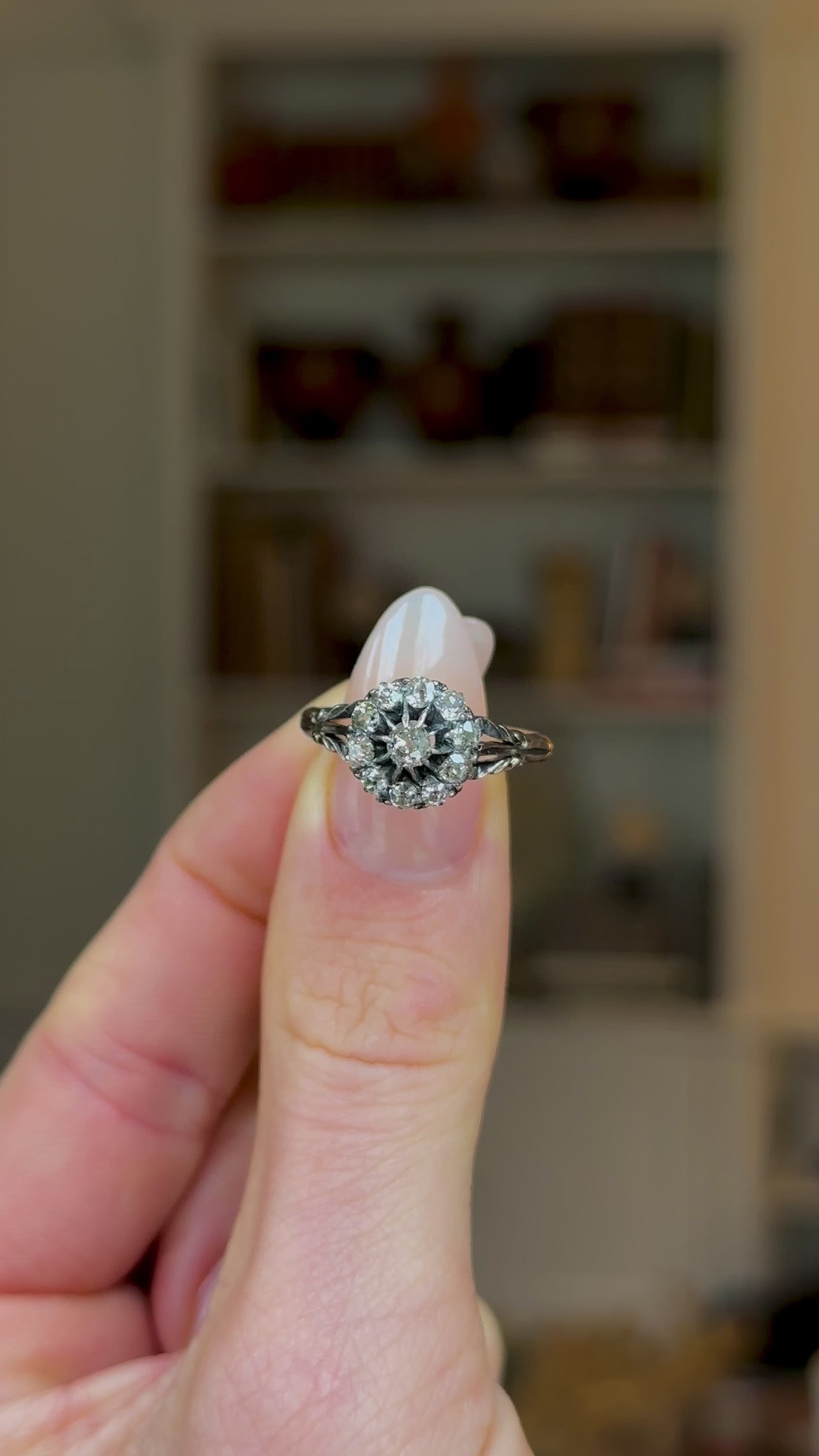 Antique, Edwardian Diamond Cluster Ring, 18ct Yellow Gold held in fingers and rotated to give perpsective.