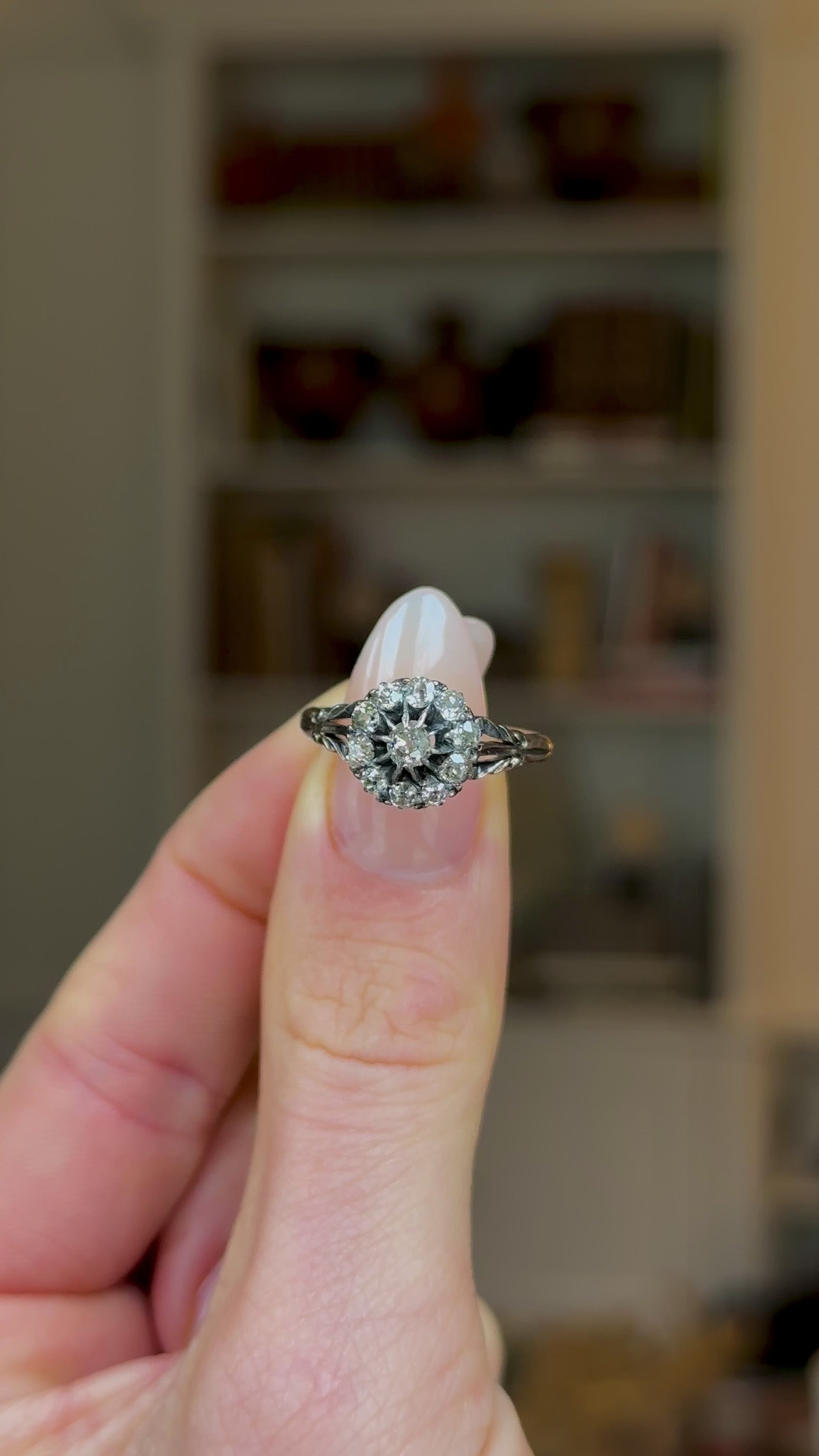 Antique, Edwardian Diamond Cluster Ring, 18ct Yellow Gold held in fingers and rotated to give perpsective.
