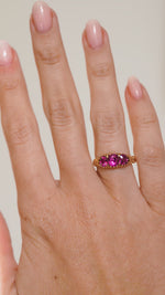 Video of the antique ruby engagement ring on the hand, capturing the depth and brilliance of all three Cambodian rubies.