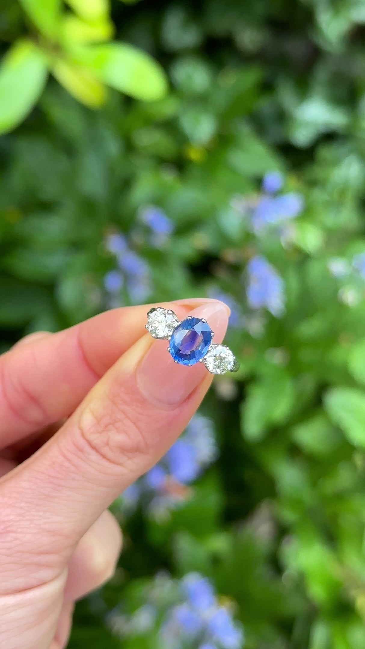 Vintage, Sapphire and Diamond Three-Stone Ring, Platinum held in fingers.