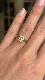 Video of a gold Vintage-inspired,  diamond rub-over solitaire engagement ring worn on a hand.