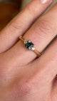 Square-cut teal sapphire and diamond three-stone engagement ring