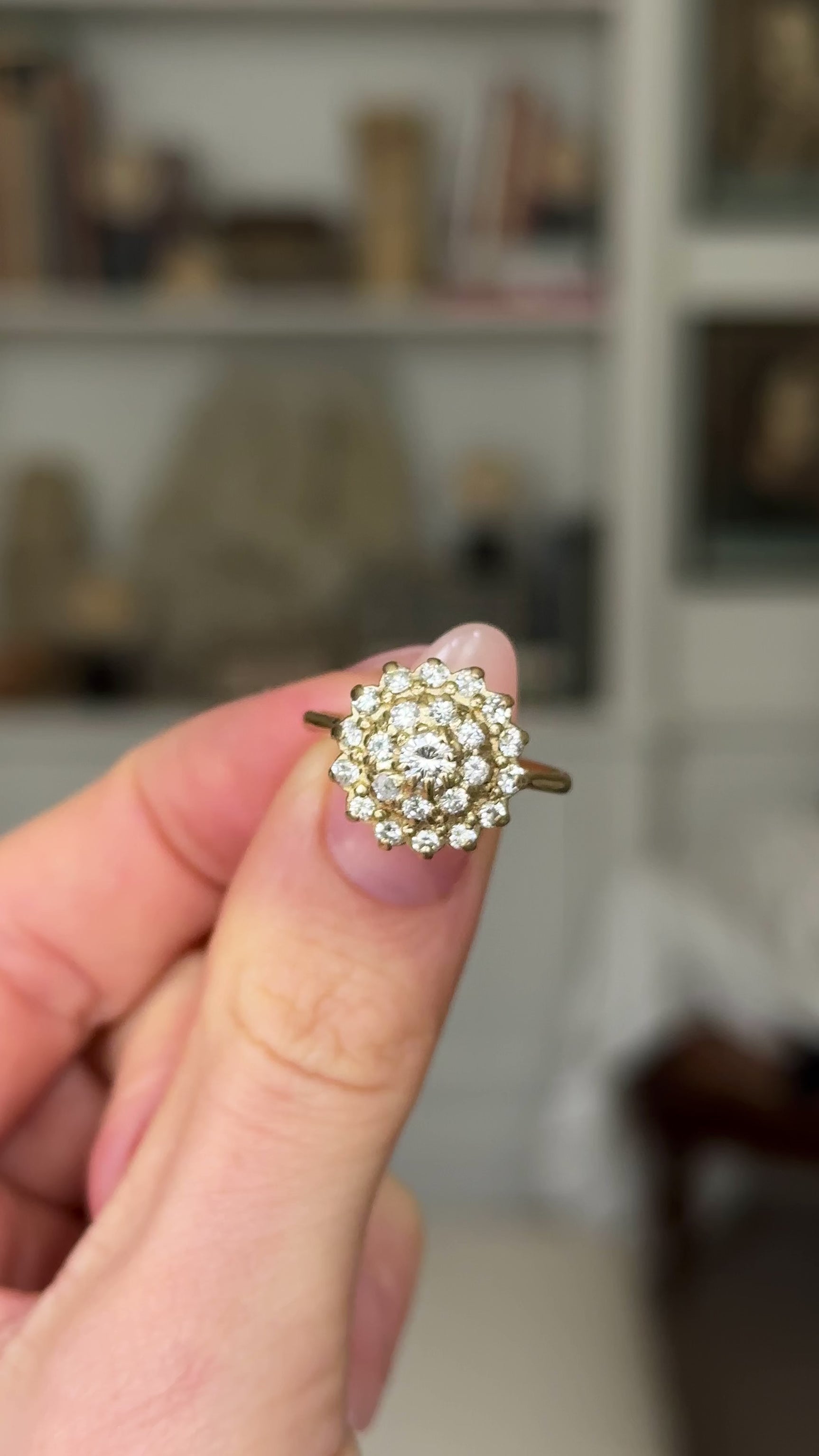 Vintage, 1970s Large Diamond Cluster Ring, 18ct Yellow Gold held in fingers and rotated to give perspective.