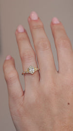 A hand-model video showcasing the pale yellow diamond and decorative gold shoulders.