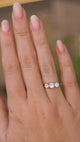 A video of a hand wearing an Antique, Edwardian diamond three-stone engagement ring in platinum to show the scale of the ring