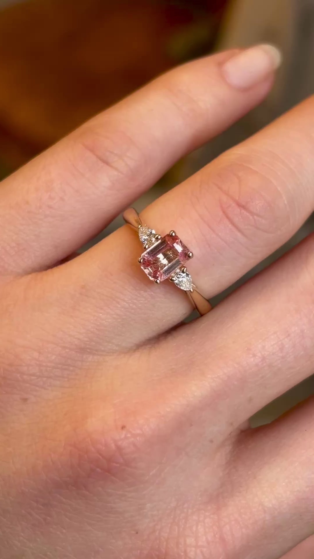 Pink sapphire and diamond three-stone engagement ring