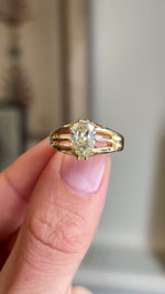 Video of a Antique, Edwardian yellow pear-cut diamond solitaire gypsy ring in yellow gold held between 2 fingers rotated to show the diamond