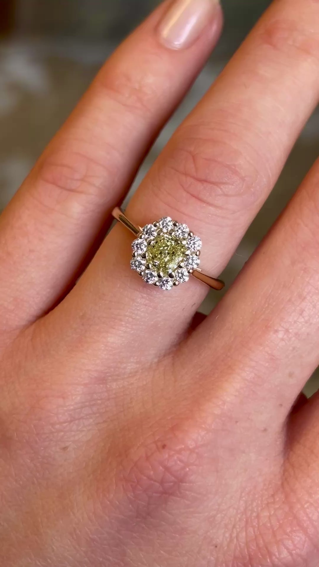 Detailed view of fancy yellow cushion-cut diamond cluster engagement ring.