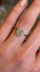 Detailed view of fancy yellow cushion-cut diamond cluster engagement ring.