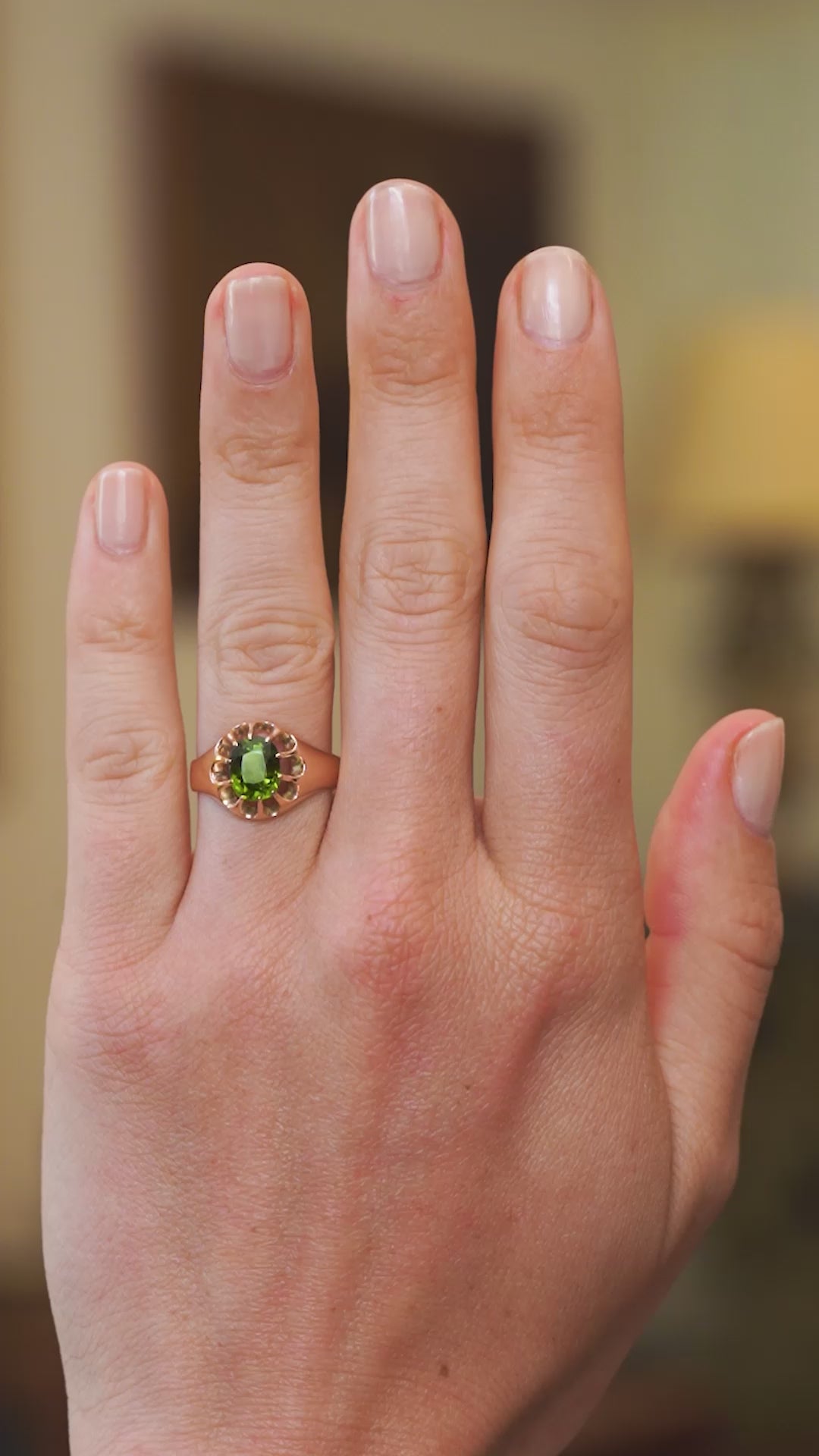 Green zircon ring worn on hand showing rich green tone and natural movement.