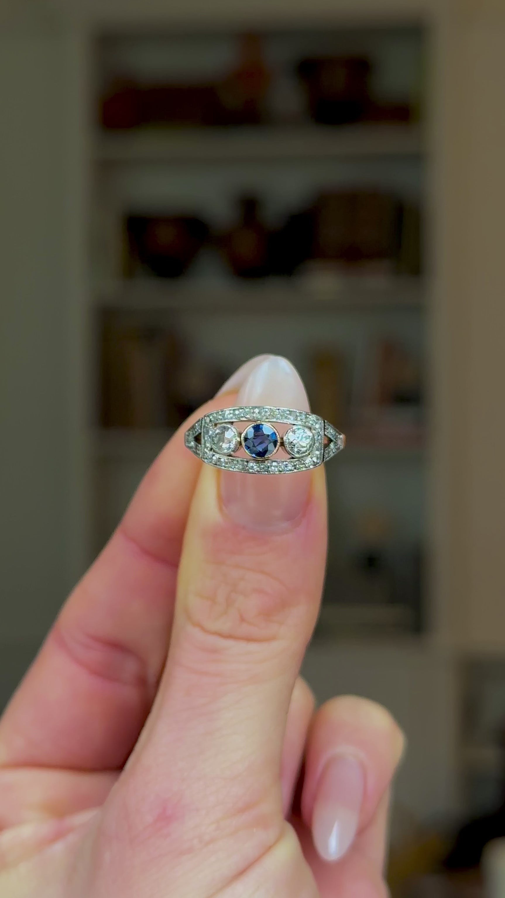 Antique, Belle Époque Sapphire and Diamond Three Stone Ring, 18ct Yellow Gold and Platinum held in fingers and rotated to give perspective.