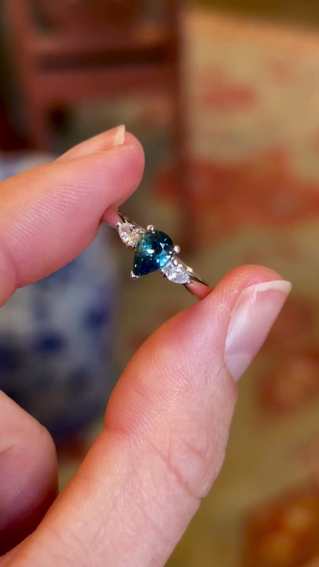 Pear-cut teal sapphire & diamond three-stone engagement ring