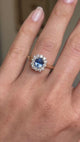 A video showing an engagement ring with an Antique-inspired, blue sapphire and diamond halo worn on a finger.