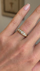 Antique Victorian old-mine cut diamond five-stone engagement ring featuring five graduated old-mine cut diamonds, displayed on a hand.