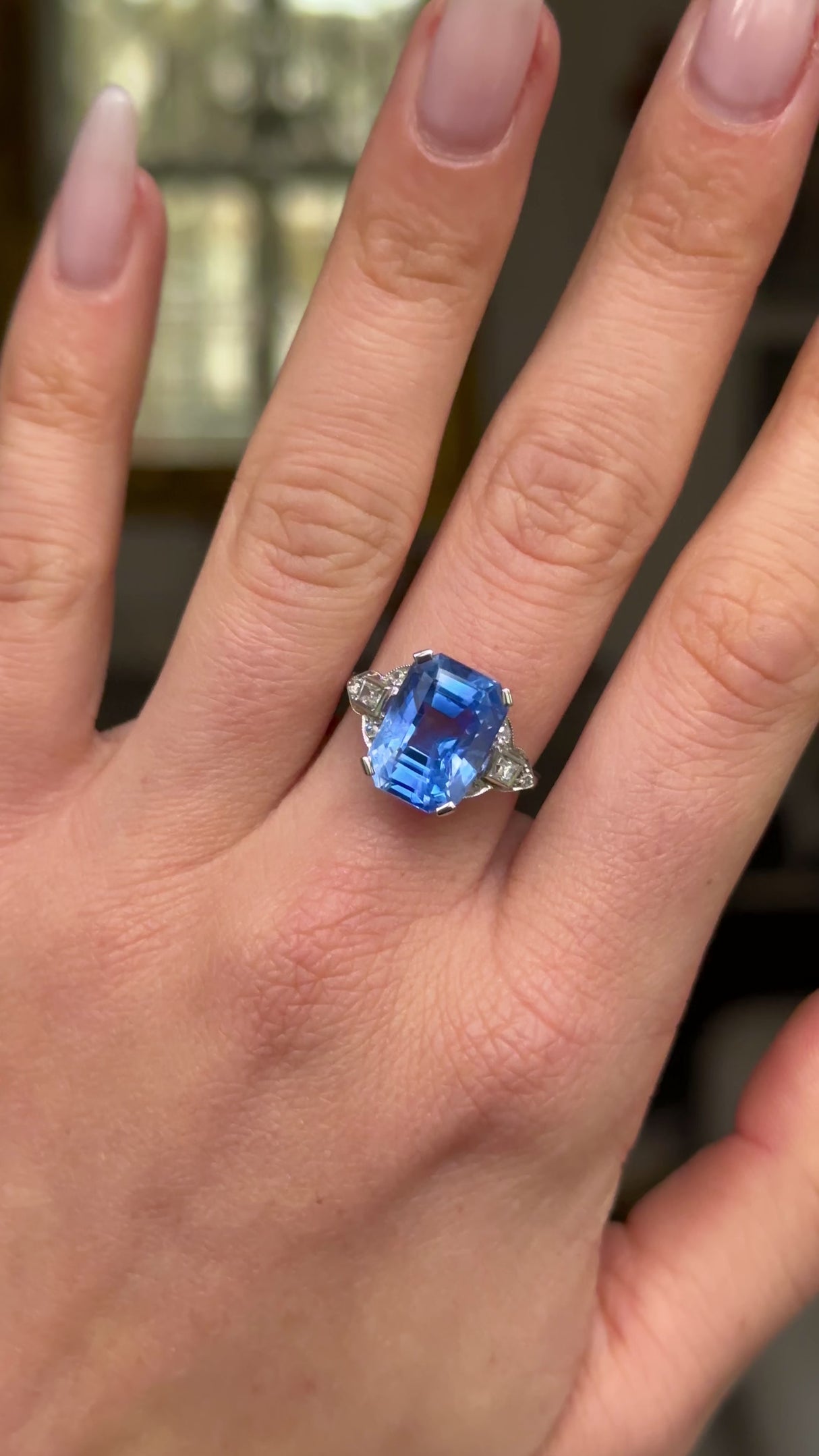 Art Deco sapphire and diamond ring worn on hand and moved around to give perspective.